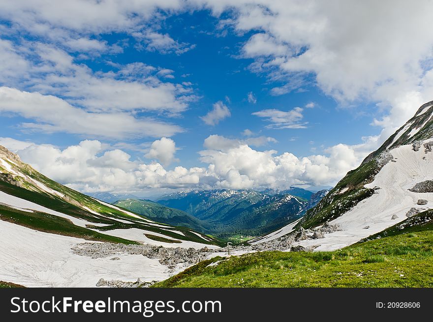 Snow and grass in the North Caucasus mountains. Russia.