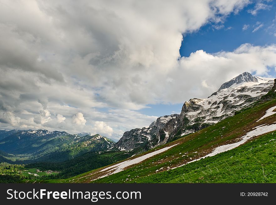 Snow and grass in the North Caucasus mountains. Russia.