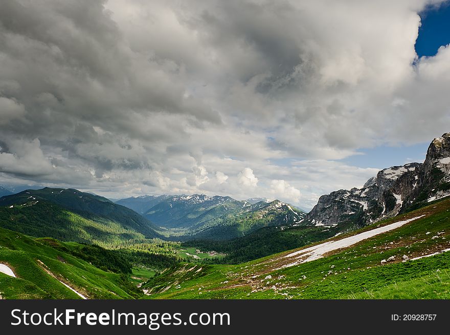 Snow and grass in the North Caucasus mountains. Russia.