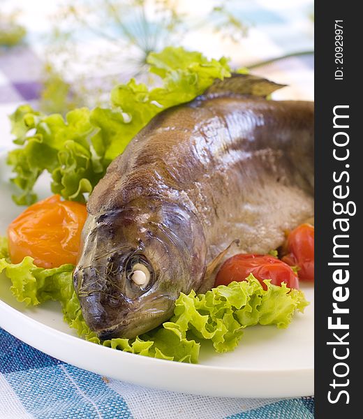 Grilled fish with lettuce and tomatoes. Selective focus