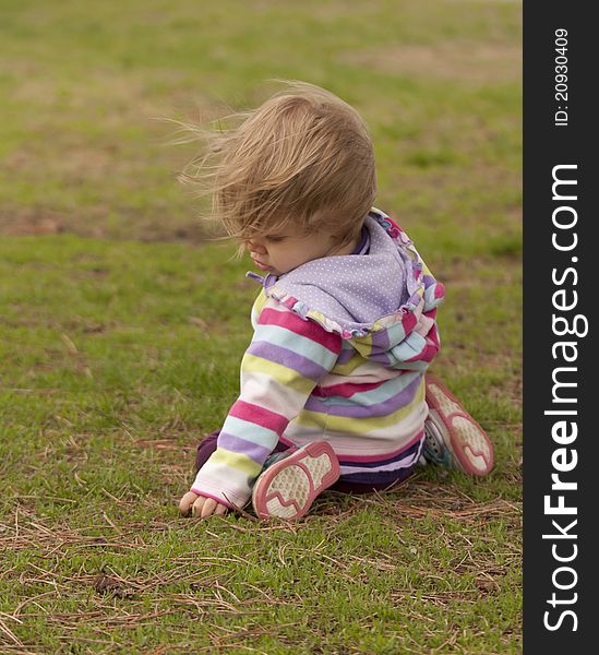 A momant captured as this curious toddler explores a park. A momant captured as this curious toddler explores a park