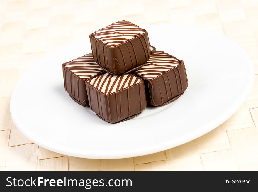 Five chocolate candies on plate