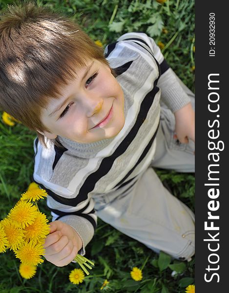 A boy with a  dandelions