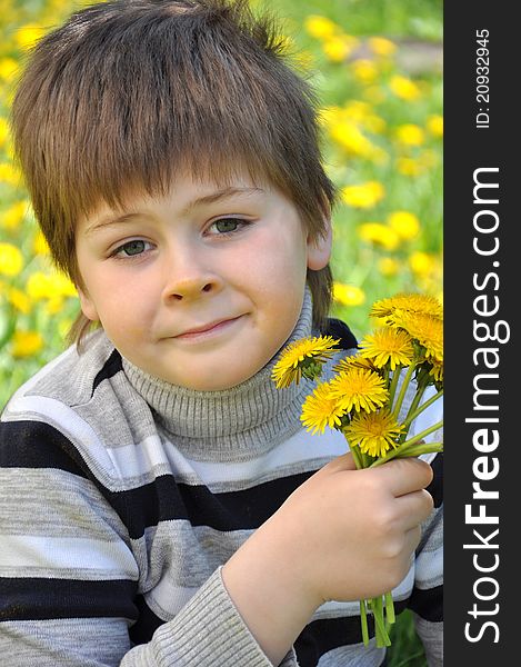 A boy with a  dandelions