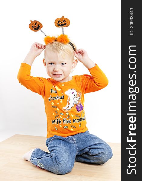 Kneeling little girl during Halloween