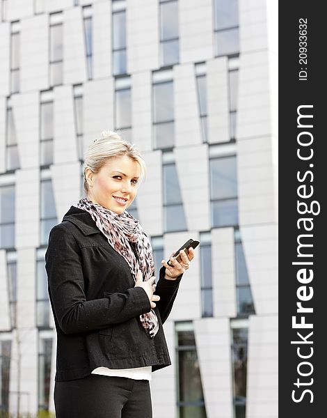 Portrait of young businesswoman with a mobile