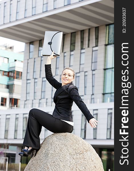 Sitting young businesswoman with a briefcase