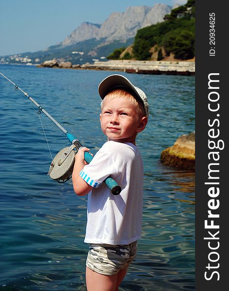 A little boy fishing in the sea. A little boy fishing in the sea