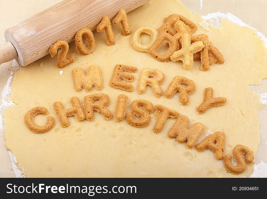 Studio-shot of preparing and baking cookies for christmas. baked letter biscuits spelling out the words merry christmas. Studio-shot of preparing and baking cookies for christmas. baked letter biscuits spelling out the words merry christmas.