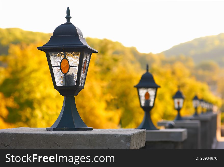 A row of old-fashioned streetlamps in autumn