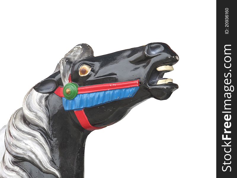 Head of an old wooden carousel horse, painted black and white with red, blue, and green trim.  Isolated on white. Head of an old wooden carousel horse, painted black and white with red, blue, and green trim.  Isolated on white.