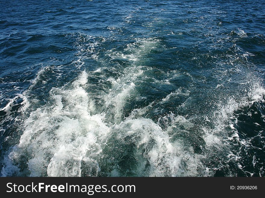 Large boat water wake trail left over the sea ocean - great boating sailing background