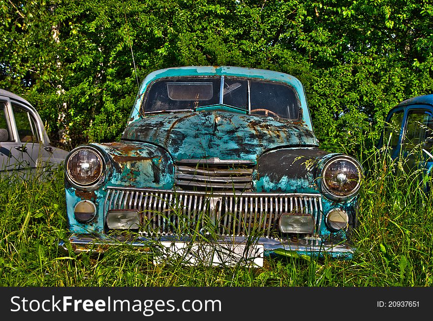 A few old cars rusting under the influence of time. A few old cars rusting under the influence of time
