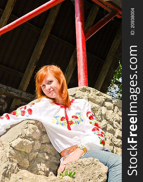 Beautiful Ukrainian girl in national clothes outdoors