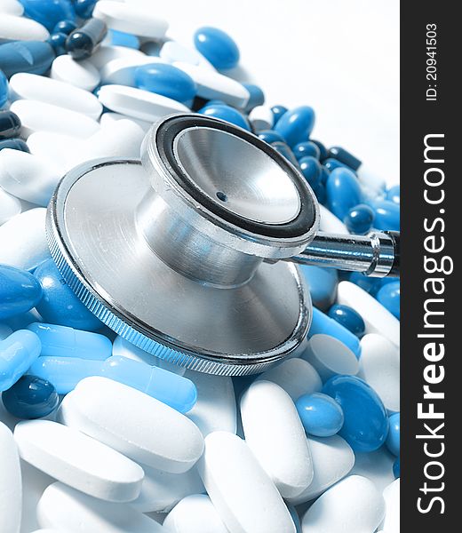 Stethoscope and colored pills,white and blue pills. Stethoscope and colored pills,white and blue pills