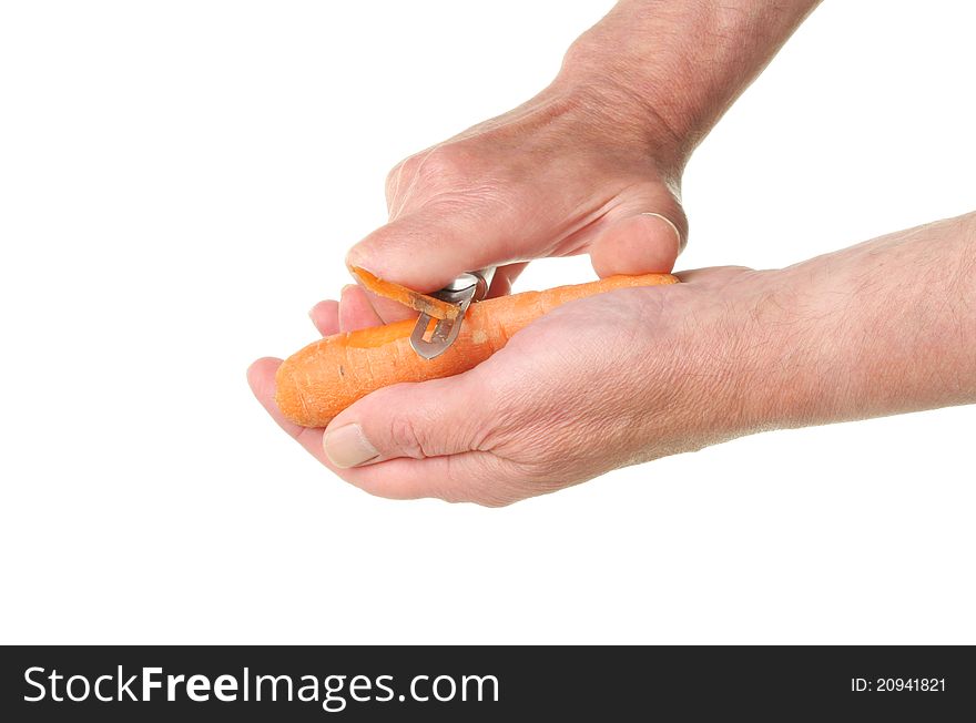 Hands peeling carrot