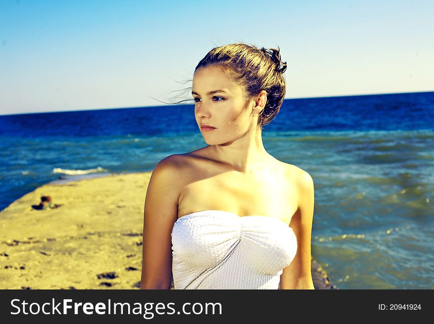 Portrait of relaxing woman sits on sand