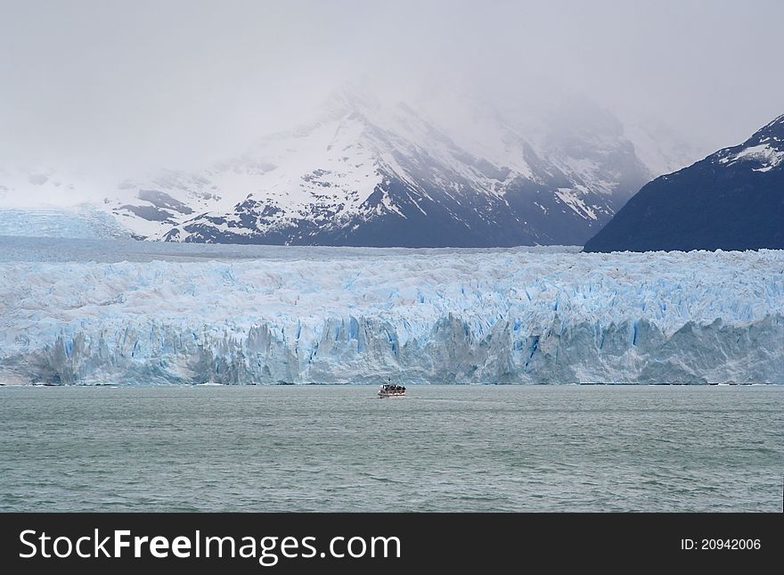 A boat is navigating to the occidental side of the perito moreno glacier. A boat is navigating to the occidental side of the perito moreno glacier