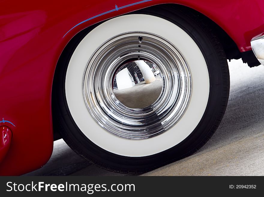 White wall tire on a red classic car