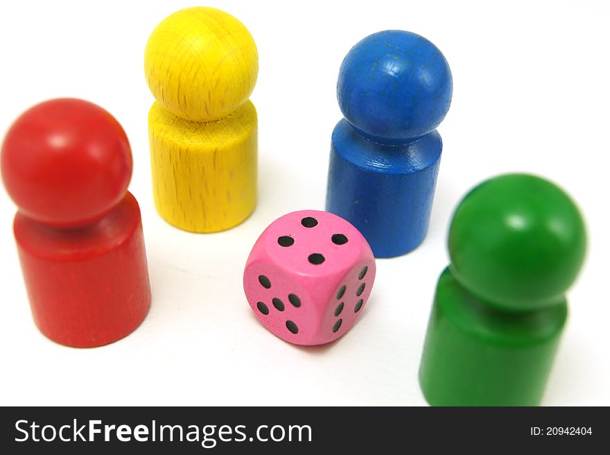 Colorful toy figures with one pink dice. Colorful toy figures with one pink dice