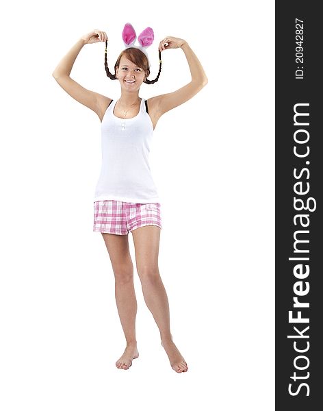 Beautiful young woman in pink shorts with rabbit ears over white