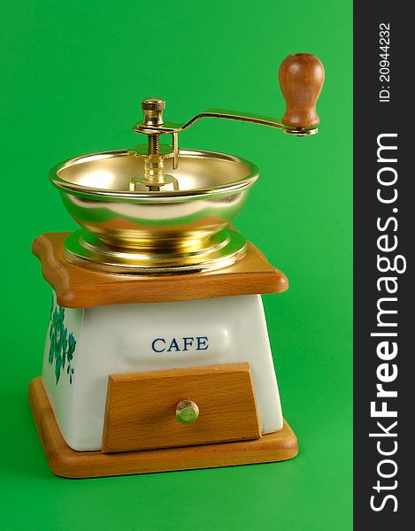 Coffee grinder close-up Isolated on green background