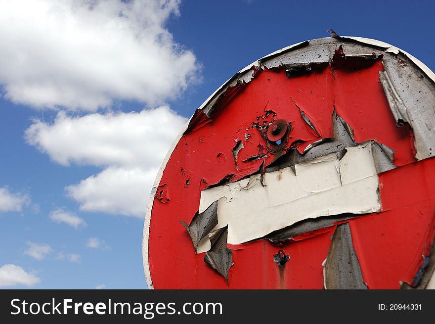 Conceptual stock photo of old red peeled No Entry road sign over blue sky background Restricted area concept Isolated with clipping path. Conceptual stock photo of old red peeled No Entry road sign over blue sky background Restricted area concept Isolated with clipping path