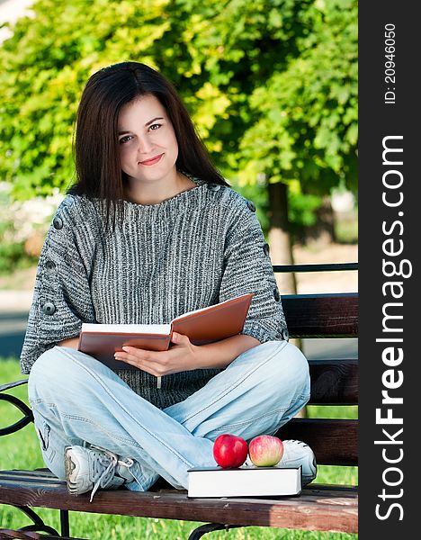 Portrait of a young female student with books at the campus