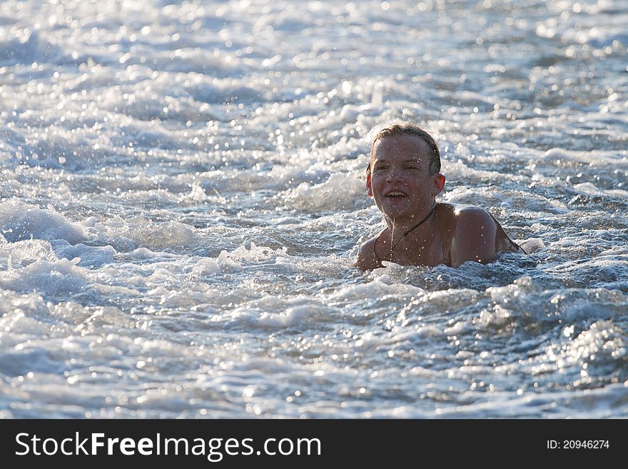 Boy bathing in the waves on the sea. Boy bathing in the waves on the sea