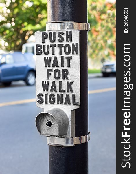 Walk signal button at a pedestrian crosswalk