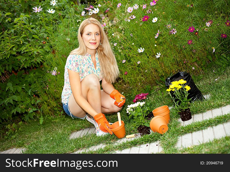 Pretty young woman with tools in the garden. Pretty young woman with tools in the garden