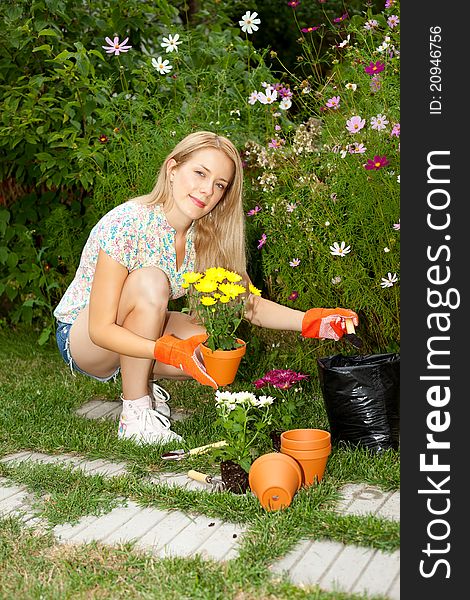 Young gardener with gardening tools planting flowers. Young gardener with gardening tools planting flowers