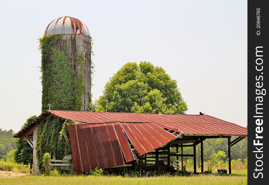 A Dilapidated Old Barn And Silo