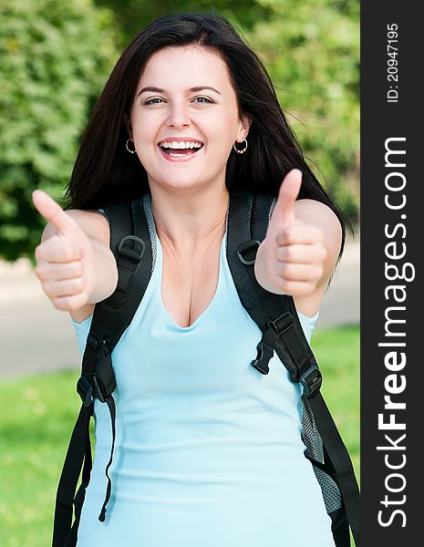 Portrait of a young female student with bag at the campus