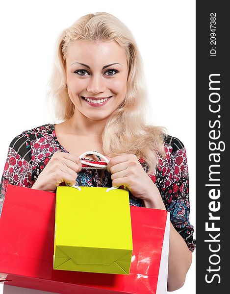 Portrait of a young woman holding a shopping bags over white background. Portrait of a young woman holding a shopping bags over white background