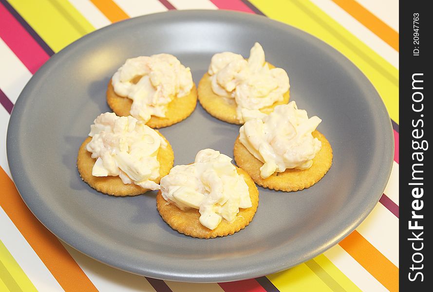 Five shrimp and egg salad on crackers