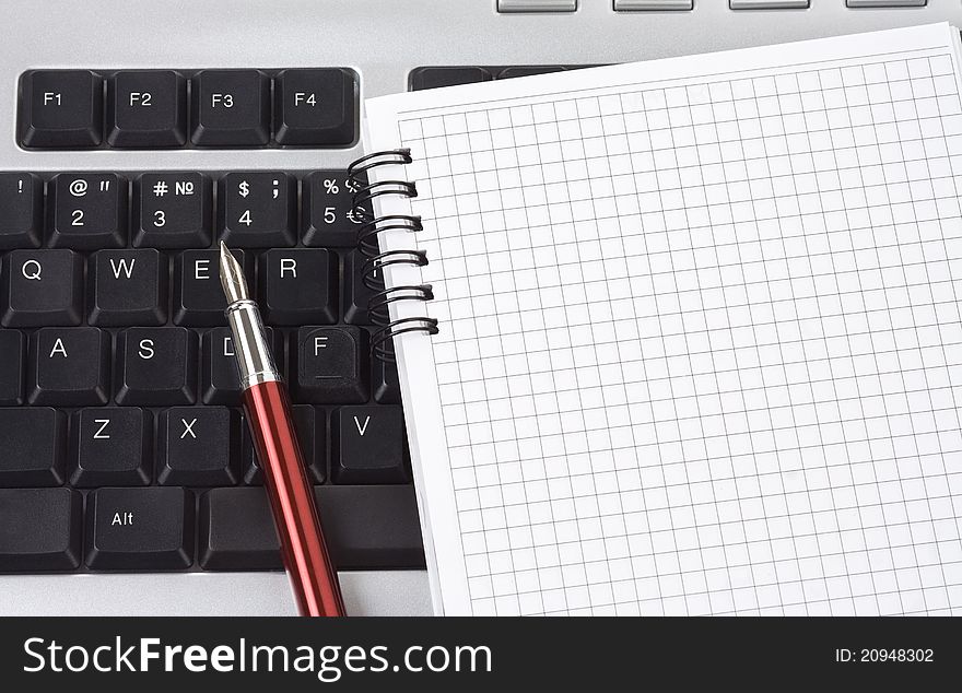 Computer keyboard and pen with notebook