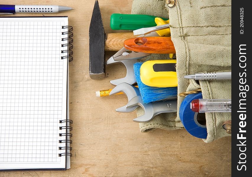 Tools and notebook on wood