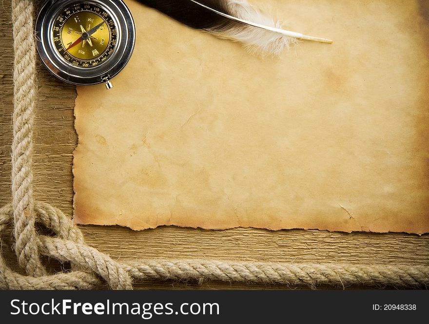 Parchment paper and feather with rope on wood