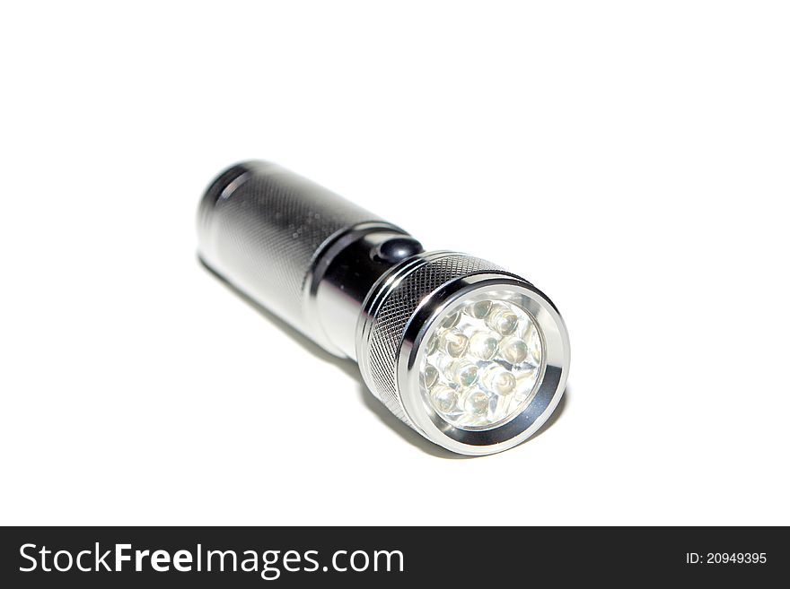 Metal flashlight in white background