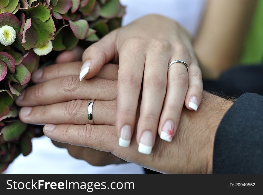 Wife´s and man´s hand together - a symbol of their marriage. Wife´s and man´s hand together - a symbol of their marriage