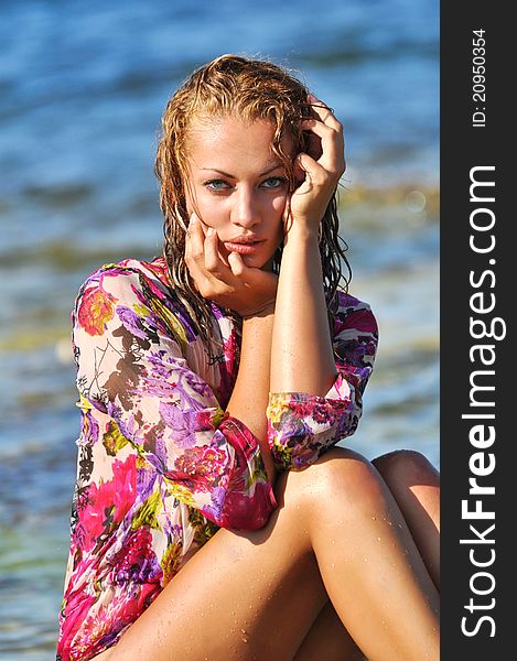 The Beautiful Young Woman On A Beach In A Wet Dres