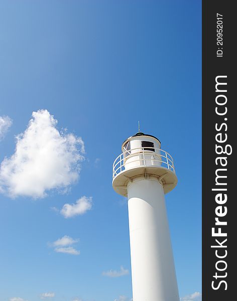 White lighthouse with a blue sky on a sunny day. White lighthouse with a blue sky on a sunny day.
