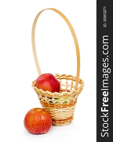 Wicker basket with apples, white background, isolated