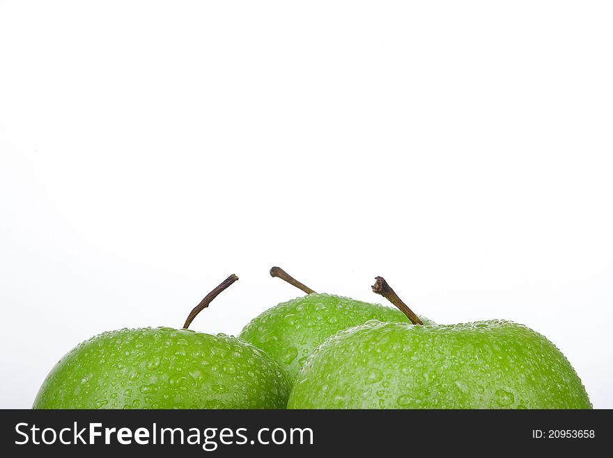 Frame of fresh Green Apple with water droplets against a white background