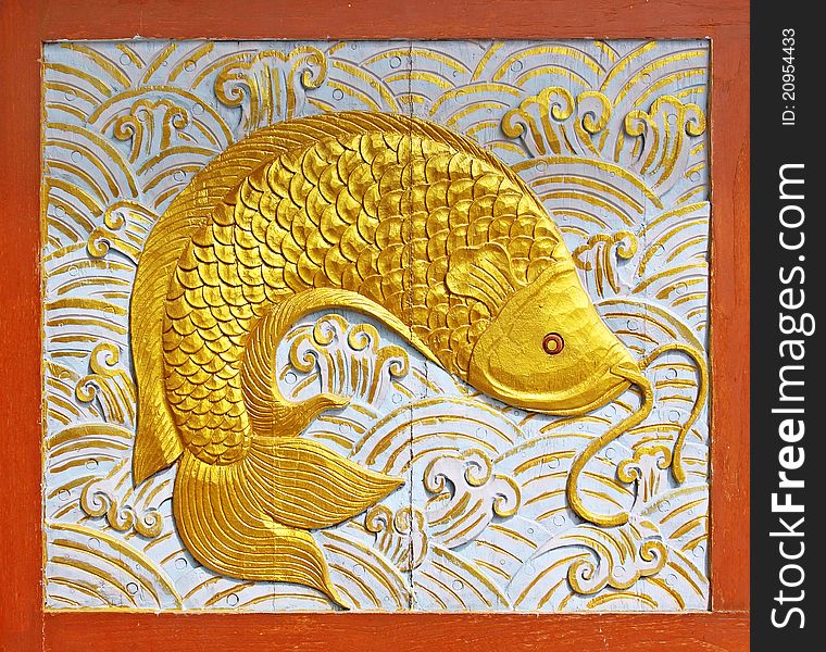 Gold fish wood texture carving background. Gold fish wood texture carving background