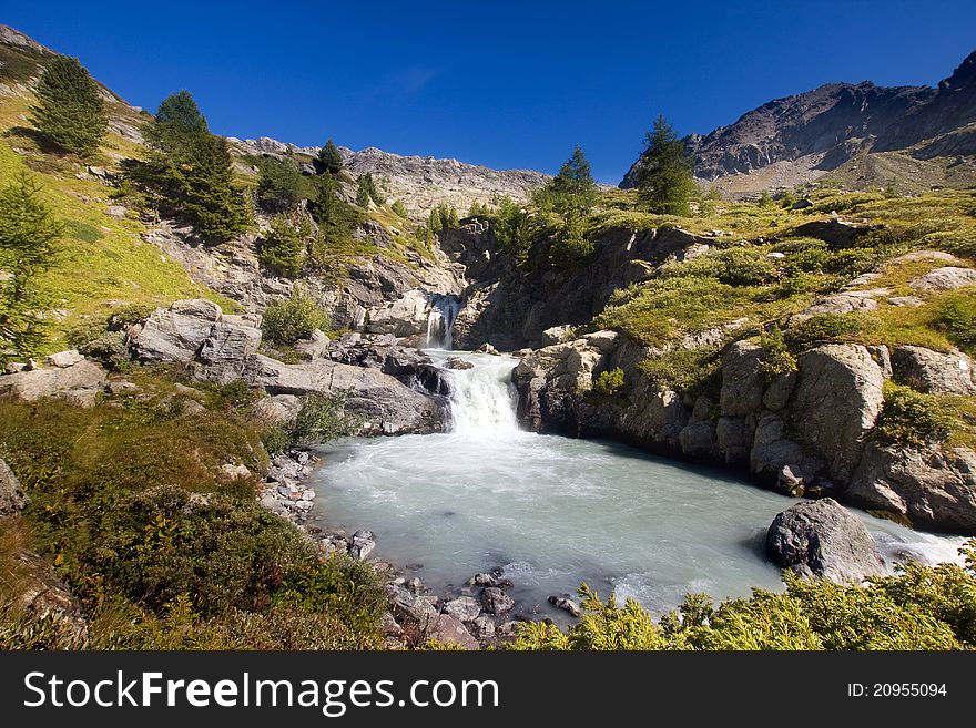 Waterfall and lake in Rutor mountain, Val d'Aosta, Italy