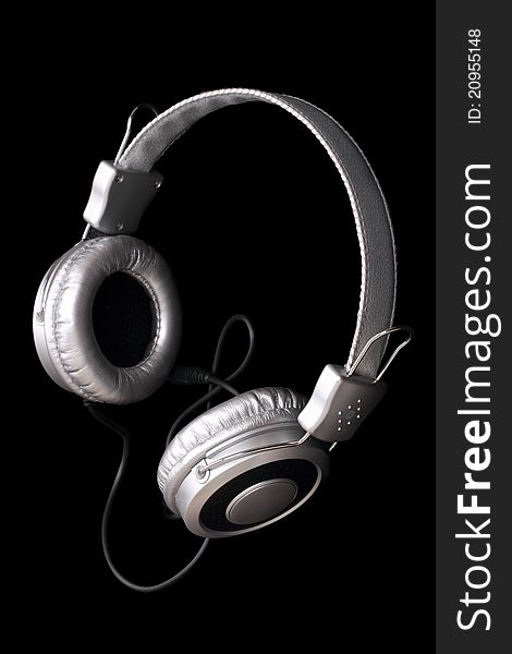 Silver stereo headphones isolated on black background. Silver stereo headphones isolated on black background