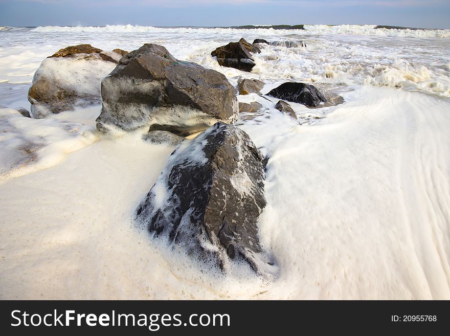 Foamy surf on the rocks as storm approaches