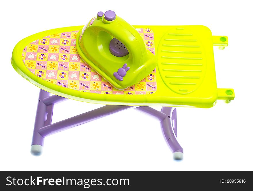 Toy iron and ironing board on white